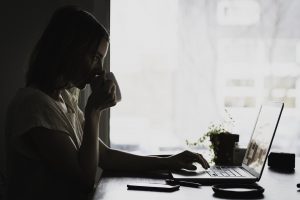 Picture of a girl at a desk experiencing art block
